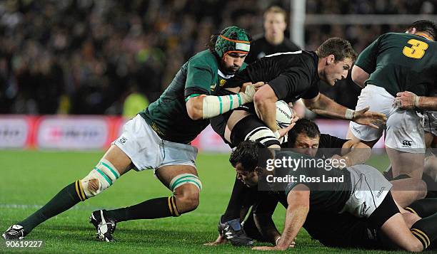 Kieran Read of the All Blacks is tackled by Victor Matfield of South Africa during the Tri Nations Test between the New Zealand All Blacks and South...