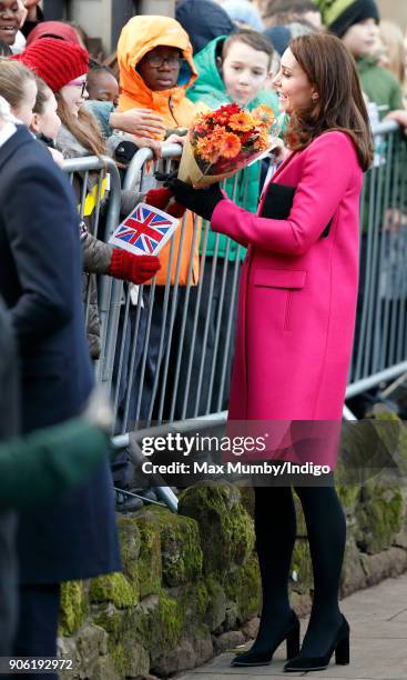 Catherine, Duchess of Cambridge receives flowers from a young girl as she visits Coventry Cathedral on January 16, 2018 in Coventry, England.