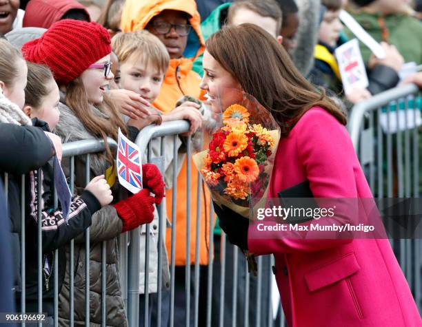 Catherine, Duchess of Cambridge receives flowers from a young girl as she visits Coventry Cathedral on January 16, 2018 in Coventry, England.