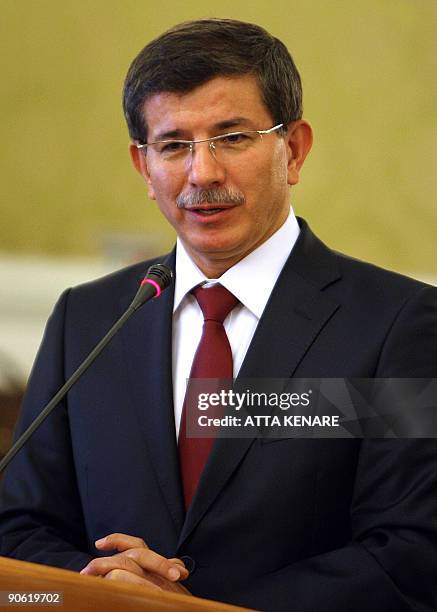 Turkish Foreign Minister Ahmet Davutoglu speaks during a joint press conference with his Iranian counterpart Manouchehr Mottaki in Tehran on...