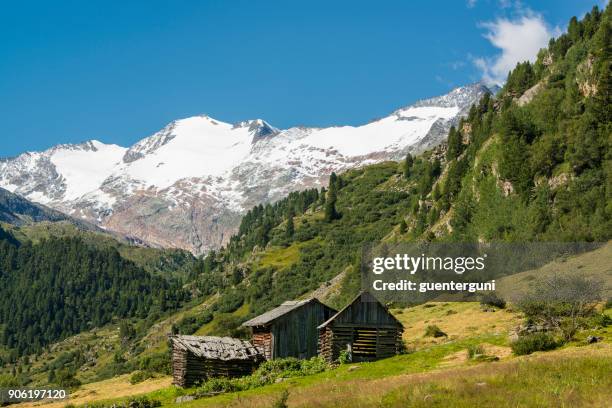 small alpine huts in the oetztal alps, north tyrol, austria - snow border stock pictures, royalty-free photos & images