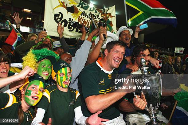 Bakkies Botha and Victor Matfield of South Africa celebrate with the Tri Nations Cup following the Tri Nations Test between the New Zealand All...