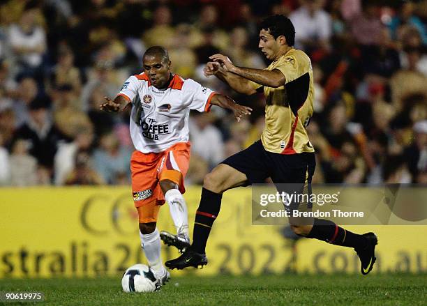 Henrique of the Roar competes with Adam D'Apuzzo of the Jets during the round six A-League match between the North Queensland Fury and the Brisbane...