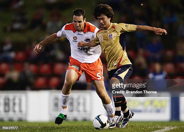 Jin-Hyung Song of the Jets competes with Josh McCloughan of the Roar during the round six A-League match between the North Queensland Fury and the...