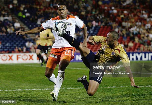 Tarek Elrich of the Jets competes with Reinaldo of the Roar during the round six A-League match between the Newcastle Jets and the Brisbane Roar at...