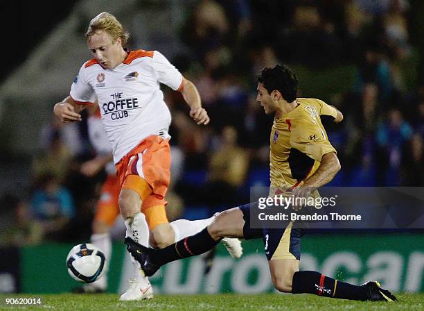Mitch Nichols of the Roar dribbles past Adam D'Apuzzo of the Jets during the round six A-League match between the Newcastle Jets and the Brisbane...
