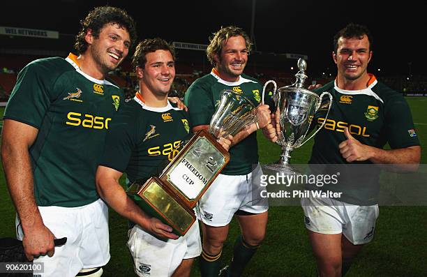 Ryan Kankowski, Heinrich Brussow, Jannie Du Plessis and Bismarck Du Plessis of South Africa celebrate with the Tri Nations and Freedom Cups following...