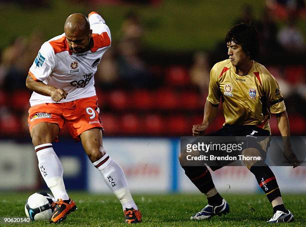 Sergio Van Dijk of the Roar competes with Jin-Hyung Song of the Jets during the round six A-League match between the North Queensland Fury and the...
