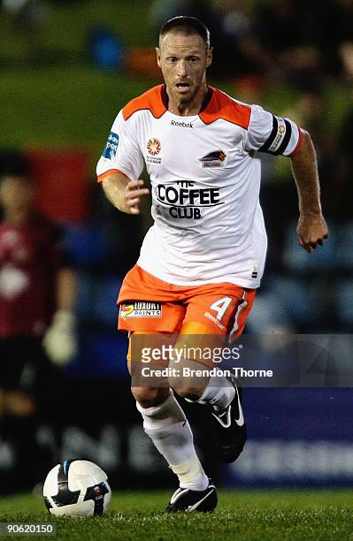 Craig Moore of the Roar dribbles the ball during the round six A-League match between the North Queensland Fury and the Brisbane Roar at...