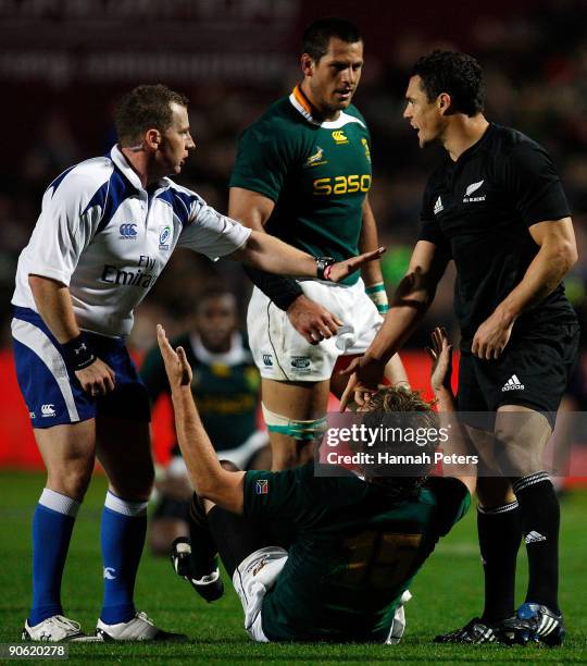 Dan Carter of New Zealand complains to referee Nigel Owens after being tackled by Frans Steyn of South Africa during the Tri Nations Test Match...