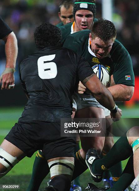 John Smit of South Africa is tackled by Jerome Kaino of New Zealand during the Tri Nations Test between the New Zealand All Blacks and South African...