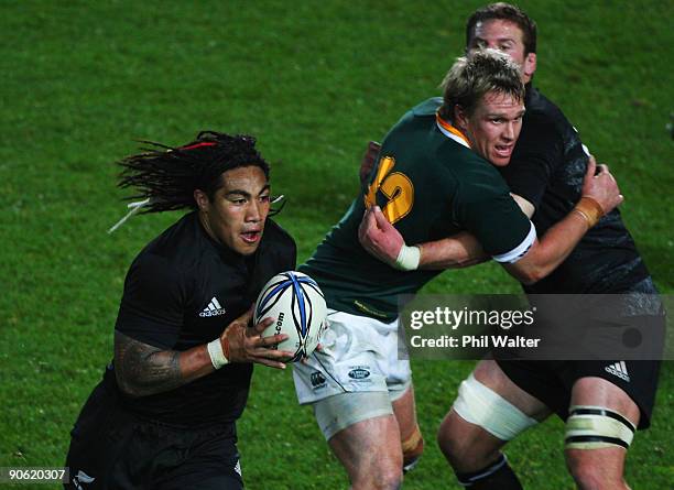 Ma'a Nonu of New Zealand runs the ball past Jean De Villiers of South Africa during the Tri Nations Test between the New Zealand All Blacks and South...