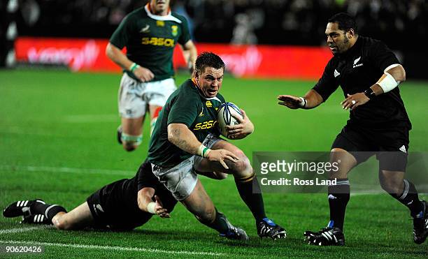 Jimmy Cowan of the All Blacks tackles John Smit of South Africa as John Afoa backs up during the Tri Nations Test between the New Zealand All Blacks...