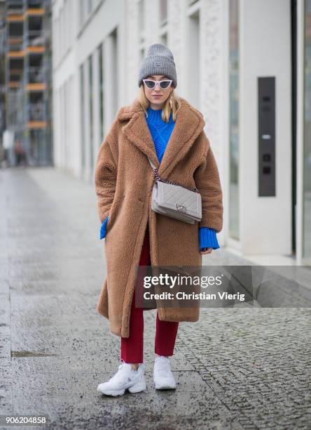 Sonia Lyson wearing brown teddy coat Max Mara, red pants, blue cropped jumper Topshop, white sneaker Reebok, grey Chanel bag, Gucci belt, Acne...