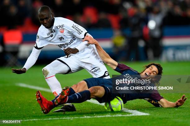 Paris Saint-Germain's Uruguayan forward Edinson Cavani is fouled by Dijon's French defender Cedric Yambere during the French L1 football match...