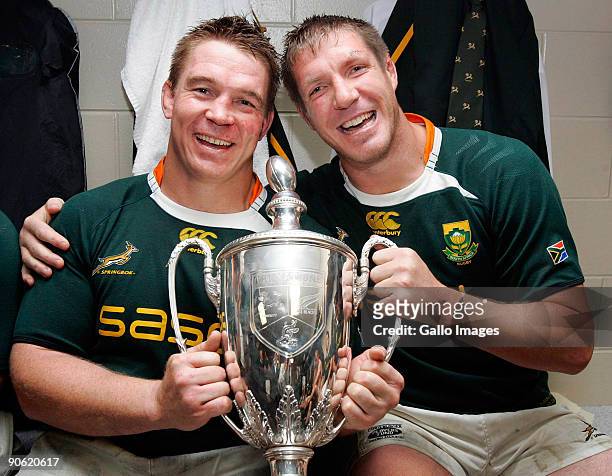John Smit and Bakkies Botha of South Africa pose in the dresssing room with the trophy after winning the Tri Nations Test between the New Zealand All...