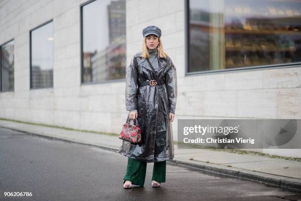 Sonia Lyson wearing raincoat plastic trench coat Asos, Miu Miu shoes, green pants Urban Outfitters, Gucci belt, flat cap Topshop, Fendi bag, earrings...