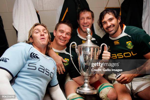 Percy Montgomery, John Smit, Bakkies Botha and Victor Matfield of South Africa pose in the dresssing room with the trophy after winning the Tri...