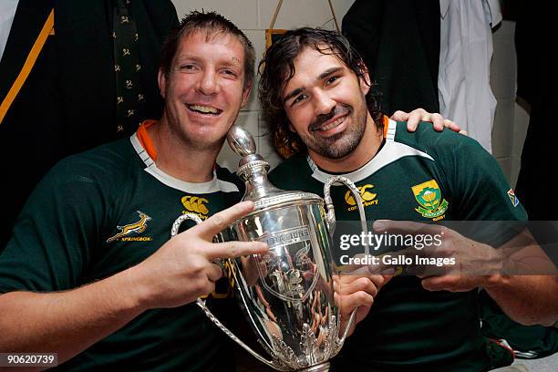 Bakkies Botha and Victor Matfield of South Africa pose in the dresssing room with the trophy after winning the Tri Nations Test between the New...