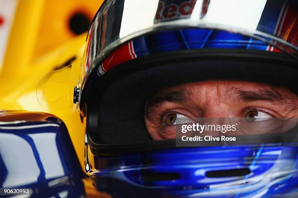 Mark Webber of Australia and Red Bull Racing prepares in his team garage during the final practice session prior to qualifying for the Italian...