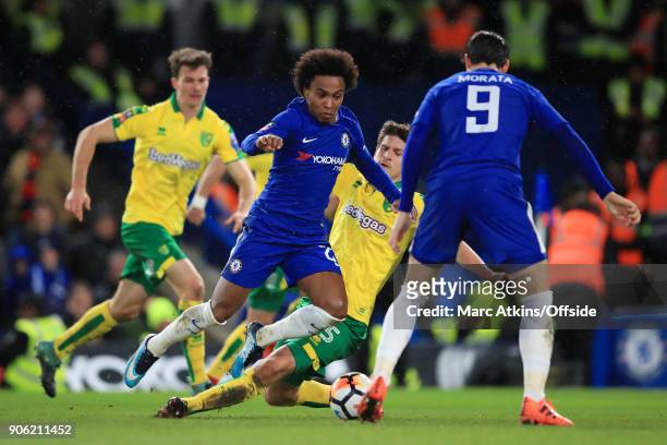 Willian of Chelsea goes down under a challenge from Timm Klose of Norwich during The Emirates FA Cup Third Round Replay match between Chelsea and...