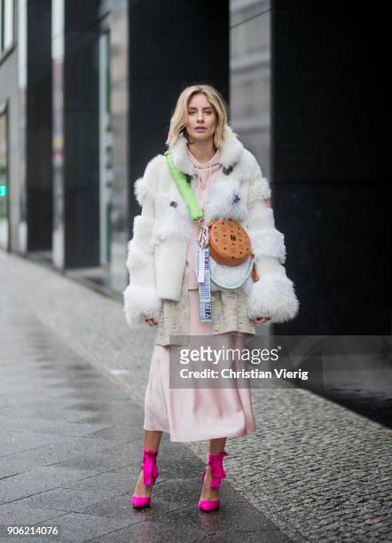 Lisa Hahnbueck wearing MCM x Koenigsouvenir bag, pink heels, rose dress, coat is seen outside Lana Mueller during the Berlin Fashion Week January...