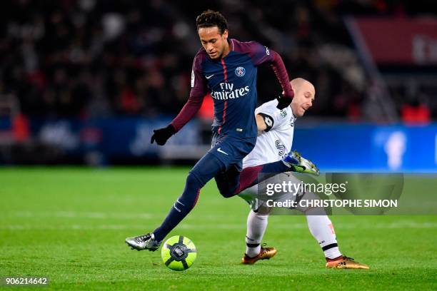 Paris Saint-Germain's Brazilian forward Neymar snatches the ball from Dijon's French midfielder Florent Balmont during the French L1 football match...