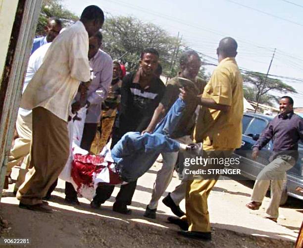 Wounded man is carried by others after demonstrators clashed with riot police in Hargeysa in the breakaway state of Somaliland, on September 12,...