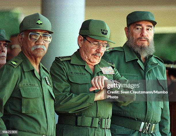 Commander of the Cuban Revolution Juan Almeida Bosque, Minister of Defense Raul Castro and President Fidel Castro look on during the 100 Anniversary...