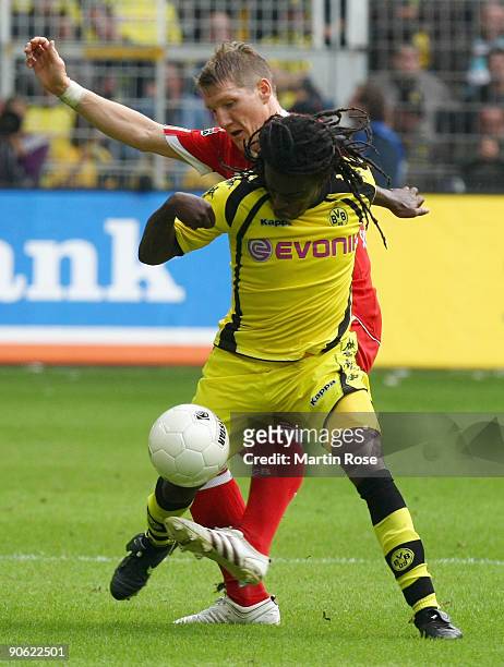 Tinga of Dortmund and Bastian Schweinsteiger of Bayern Munich battle for the ball during the Bundesliga match between Borussia Dortmund and FC Bayern...