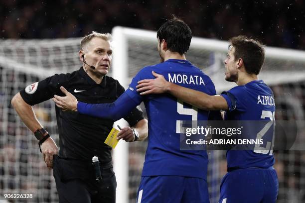 Chelsea's Spanish striker Alvaro Morata gestures to referee Graham Scott as he gets a yellow card during the FA Cup third round replay football match...