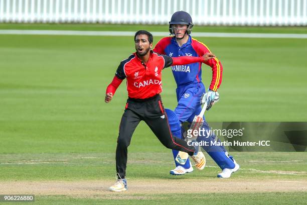 Faisal Jamkhandi of Canada bowls and Lohan Louwrens of Namibia bats during the ICC U19 Cricket World Cup match between Namibia and Canada at Bert...