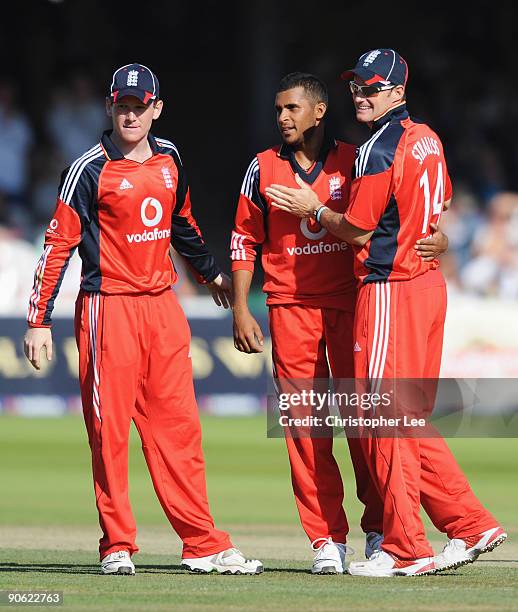 Adil Rashid of England is congratulated by Andrew Strauss and Eoin Morgan of England after taking the wicket of Tim Paine of Australia during the 4th...