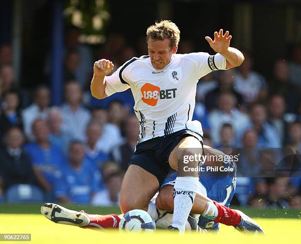 Tal Ben Haim of Portsmouth brings down Kevin Davies of Bolton Wanderers in the penalty box and gives them a penalty during the Barclays Premier...