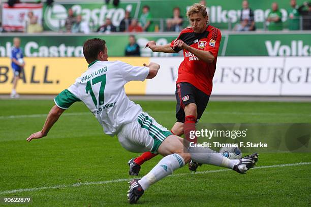 Stefan Kiessling of Leverkusen scores his team's third goal against Alexander Madlung during the Bundesliga match between VfL Wolfsburg and Bayer...