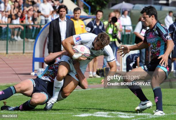 Paris' Mirco Bergamasco tackles Castres' winger Mathieu Nicolas during the French Top14 rugby union match Stade francais Paris vs. Castres on...