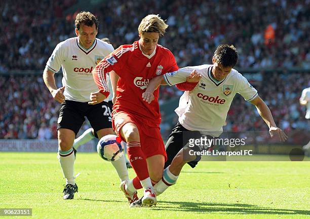 Fernando Torres of Liverpool battles with Stephen Jordan during the Barclays Premier League match between Liverpool and Burnley at Anfield on...
