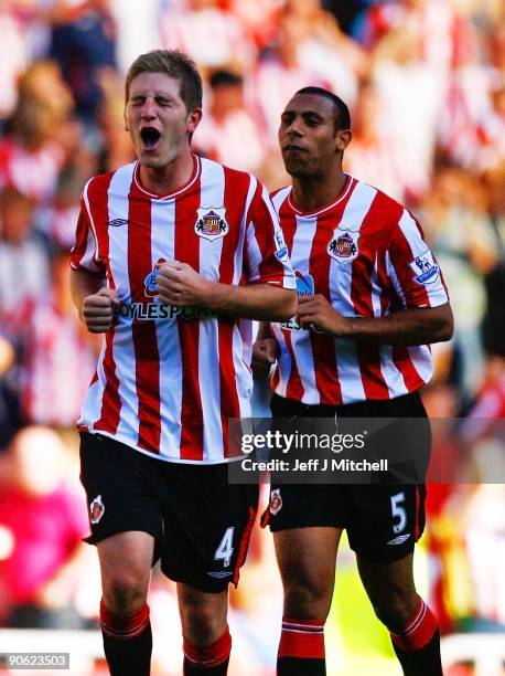 Michael Turner of Sunderland celebrates their fourth goal with team mate Anton Ferdinand during the Barclays Premier League match between Sunderland...
