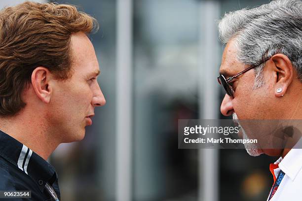 Red Bull Racing Team Principal Christian Horner and Force India Chairman Vijay Mallya talk in the paddock following qualifying for the Italian...