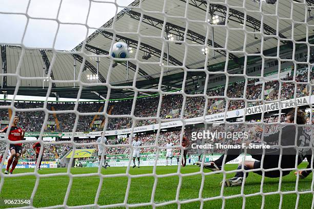 Simon Rolfes of Leverkusen scores a penalty kick against Andre Lenz of Wolfsburg during the Bundesliga match between VfL Wolfsburg and Bayer...