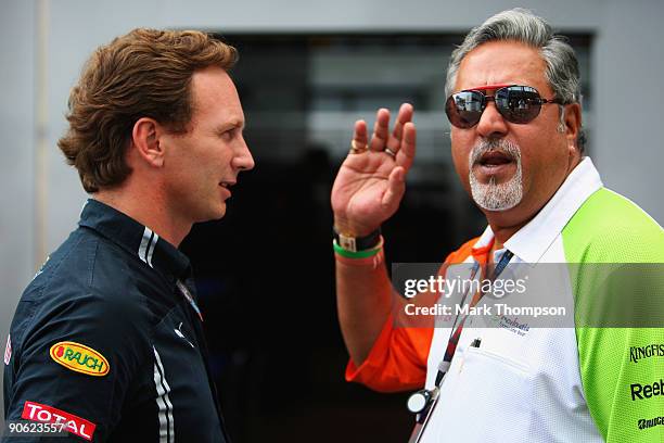 Red Bull Racing Team Principal Christian Horner and Force India Chairman Vijay Mallya talk in the paddock following qualifying for the Italian...