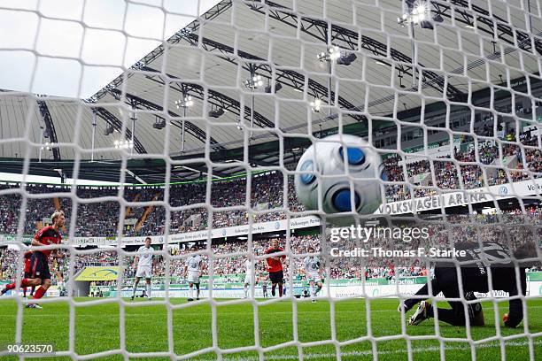 Simon Rolfes of Leverkusen shots a penalty kick against Andre Lenz of Wolfsburg during the Bundesliga match between VfL Wolfsburg and Bayer...