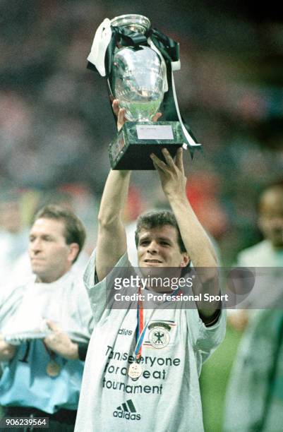 Andreas Moller of Germany holds the trophy aloft following the UEFA Euro96 final at Wembley Stadium in London on 30th June 1996. Germany won 2-1...