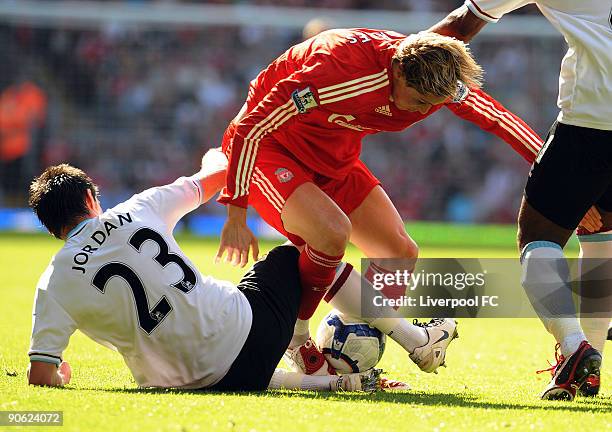 Fernando Torres of Liverpool is tackled by Stephen Jordan of Burnley during the Barclays Premier League match between Liverpool and Burnley at...