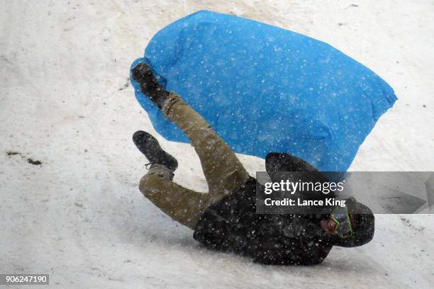 Man crashes while sledding down a hill at Dorothea Dix Park during a snow storm on January 17, 2018 in Raleigh, North Carolina. North Carolina Gov....