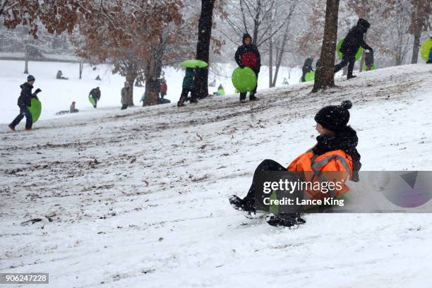 Young boy sleds at Dorothea Dix Park during a snow storm on January 17, 2018 in Raleigh, North Carolina. North Carolina Gov. Roy Cooper declared a...