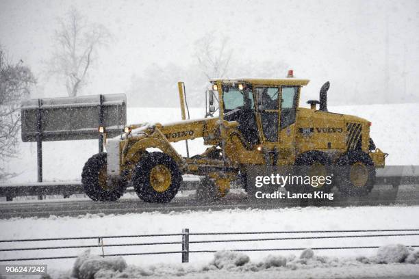 Snow plow moves along Wade Avenue during a snow storm on January 17, 2018 in Raleigh, North Carolina. North Carolina Gov. Roy Cooper declared a state...