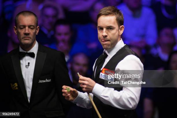 Ali Carter of England reacts during his first round match against Shaun Murphy of England on day four of The Dafabet Masters at Alexandra Palace on...