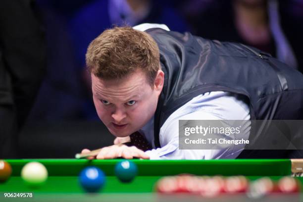 Shaun Murphy of England plays a shot during his first round match against Ali Carter of England on day four of The Dafabet Masters at Alexandra...