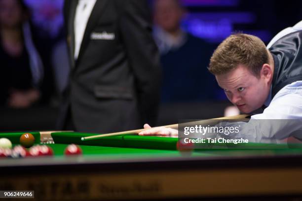 Shaun Murphy of England plays a shot during his first round match against Ali Carter of England on day four of The Dafabet Masters at Alexandra...